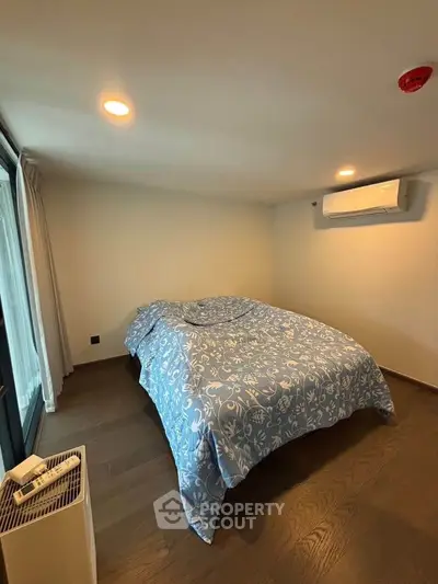 Cozy bedroom with air conditioning and stylish bedding in modern apartment