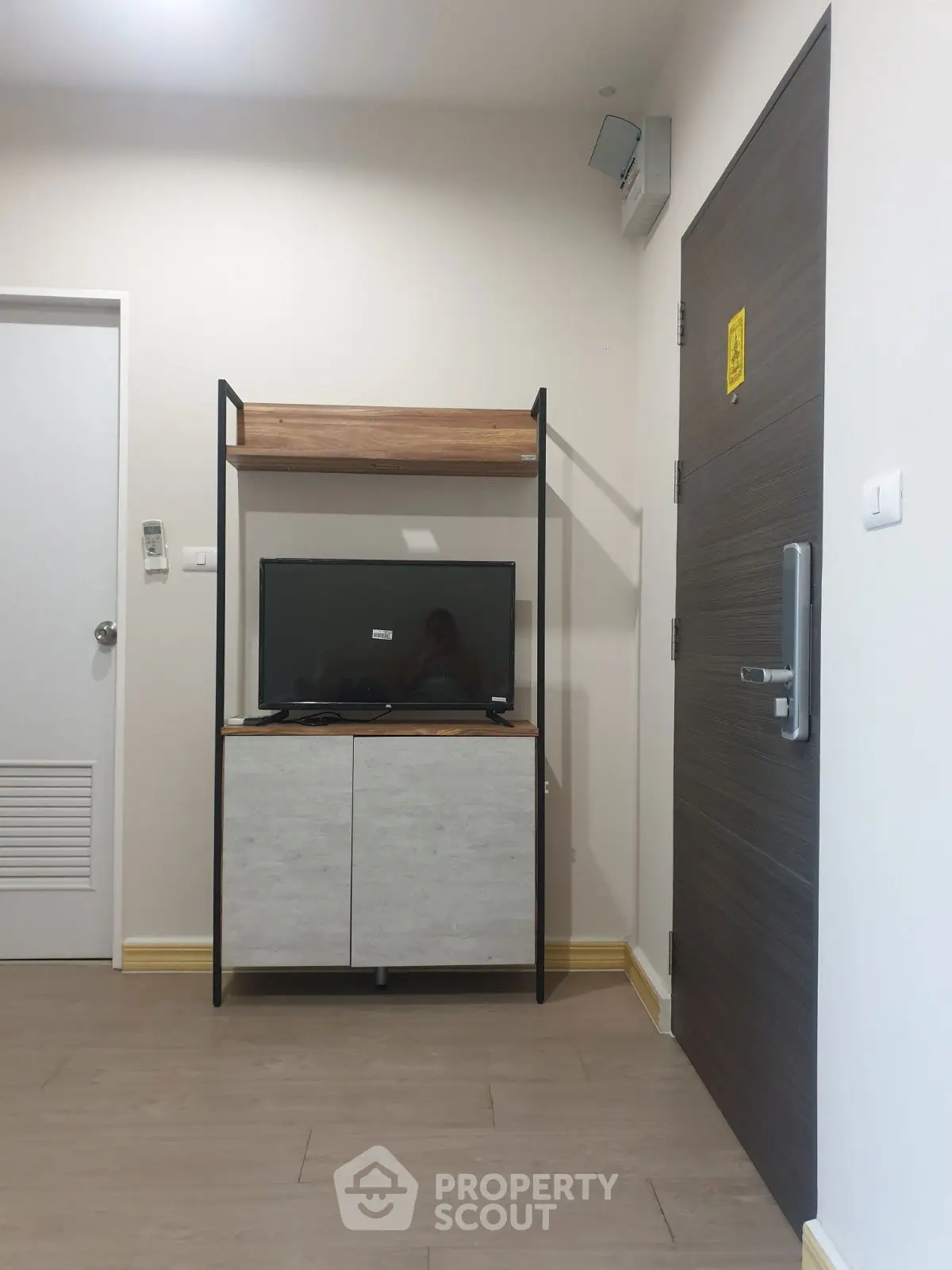 Modern living room corner with TV stand and wooden flooring