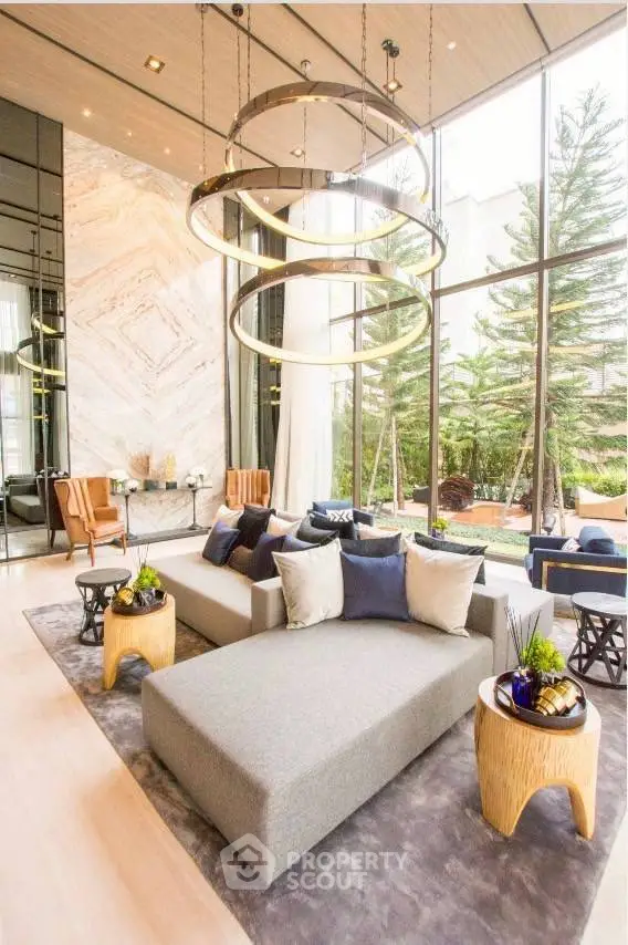 Luxurious living room with modern decor and large windows overlooking a lush garden.