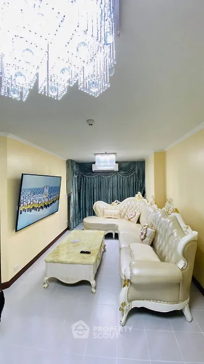 Luxurious living room with elegant chandelier and plush seating in a stylish interior.
