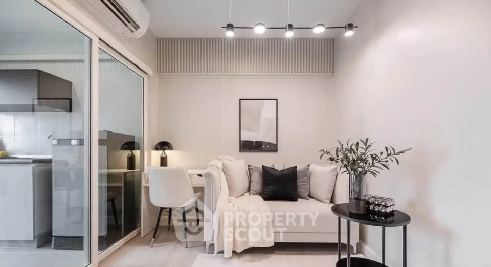 Modern living room with cozy sofa, stylish decor, and open kitchen layout in a chic apartment.