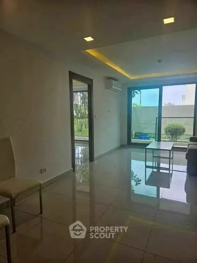 Spacious modern living room with large windows and garden view