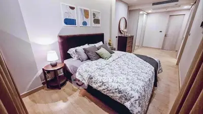 Elegant bedroom with stylish decor and cozy bedding in modern apartment.
