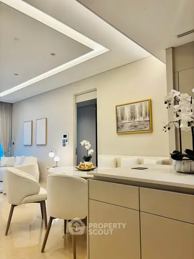 Luxurious modern living room with elegant decor and open layout, featuring plush seating and stylish lighting.
