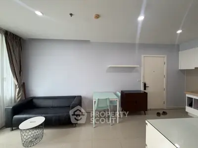 Modern living room with sleek black sofa and minimalist decor