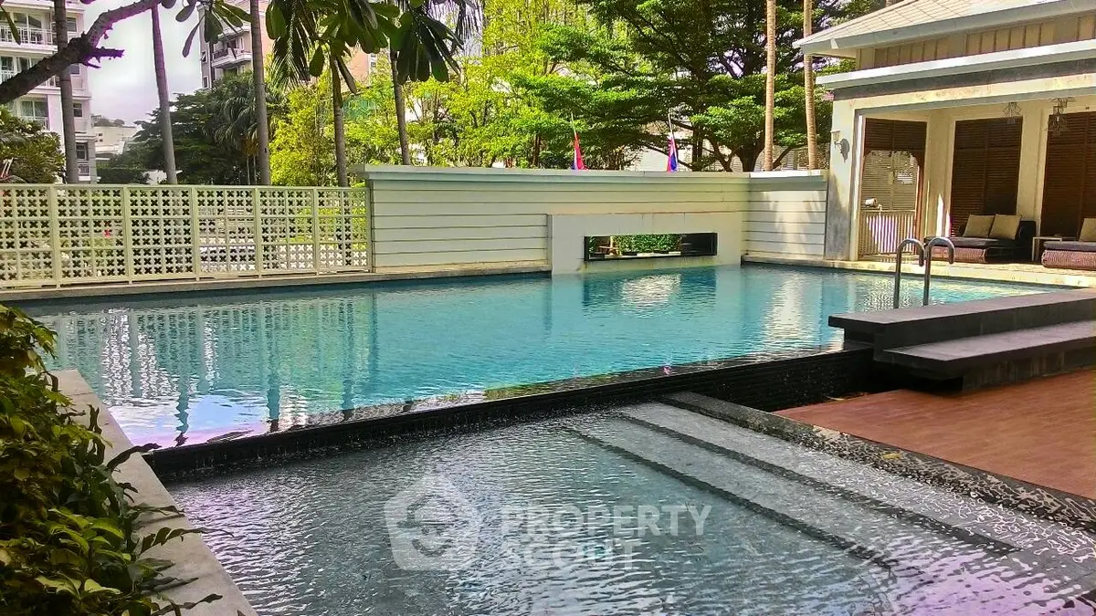 Luxurious residential pool with modern design and lush greenery