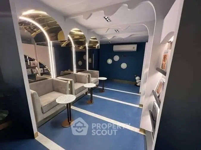 Unique futuristic living room with arched metallic ceilings, plush sofas, and artistic wall decor, creating a luxurious and innovative space.