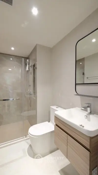 Modern bathroom with sleek fixtures and spacious shower in contemporary home.