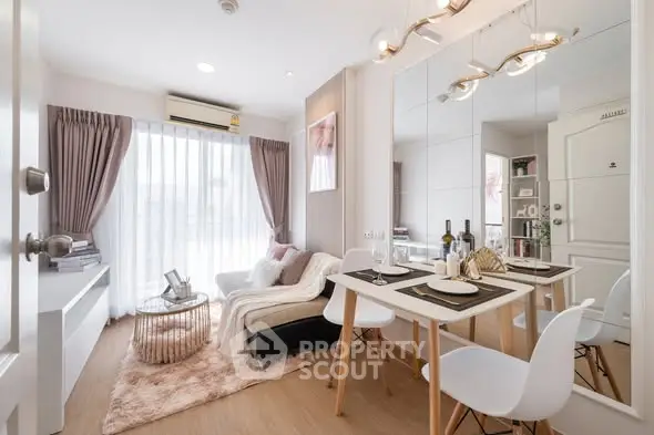 Modern living room with elegant decor and dining area, featuring stylish furniture and natural light.