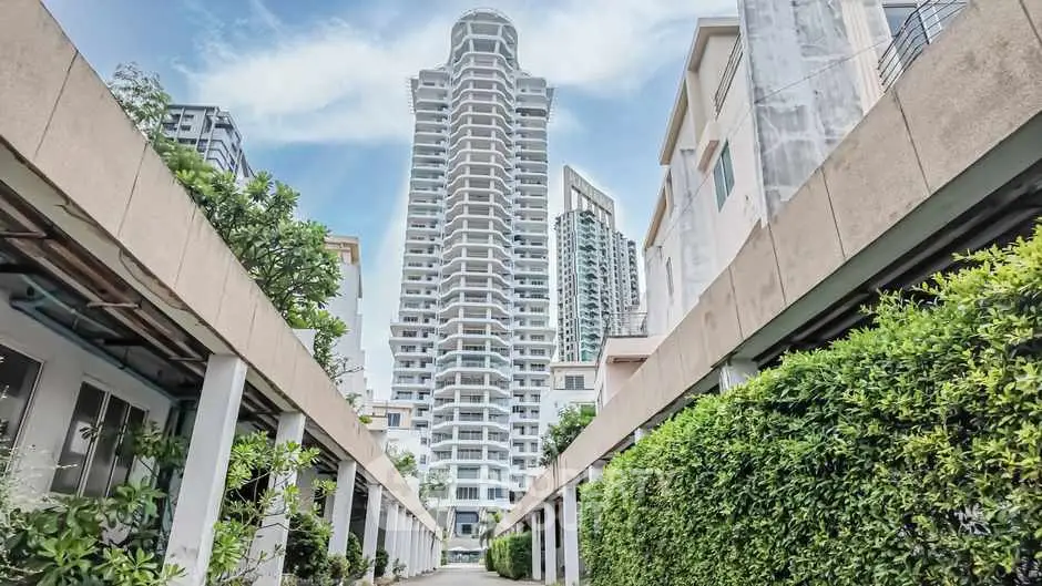 Stunning high-rise building with lush greenery and modern architecture.