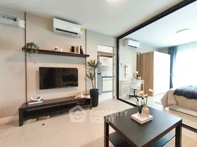 Modern open-plan living room with stylish decor and integrated bedroom view