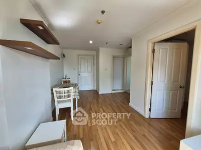 Charming apartment interior with wooden flooring and cozy dining area, perfect for modern living.
