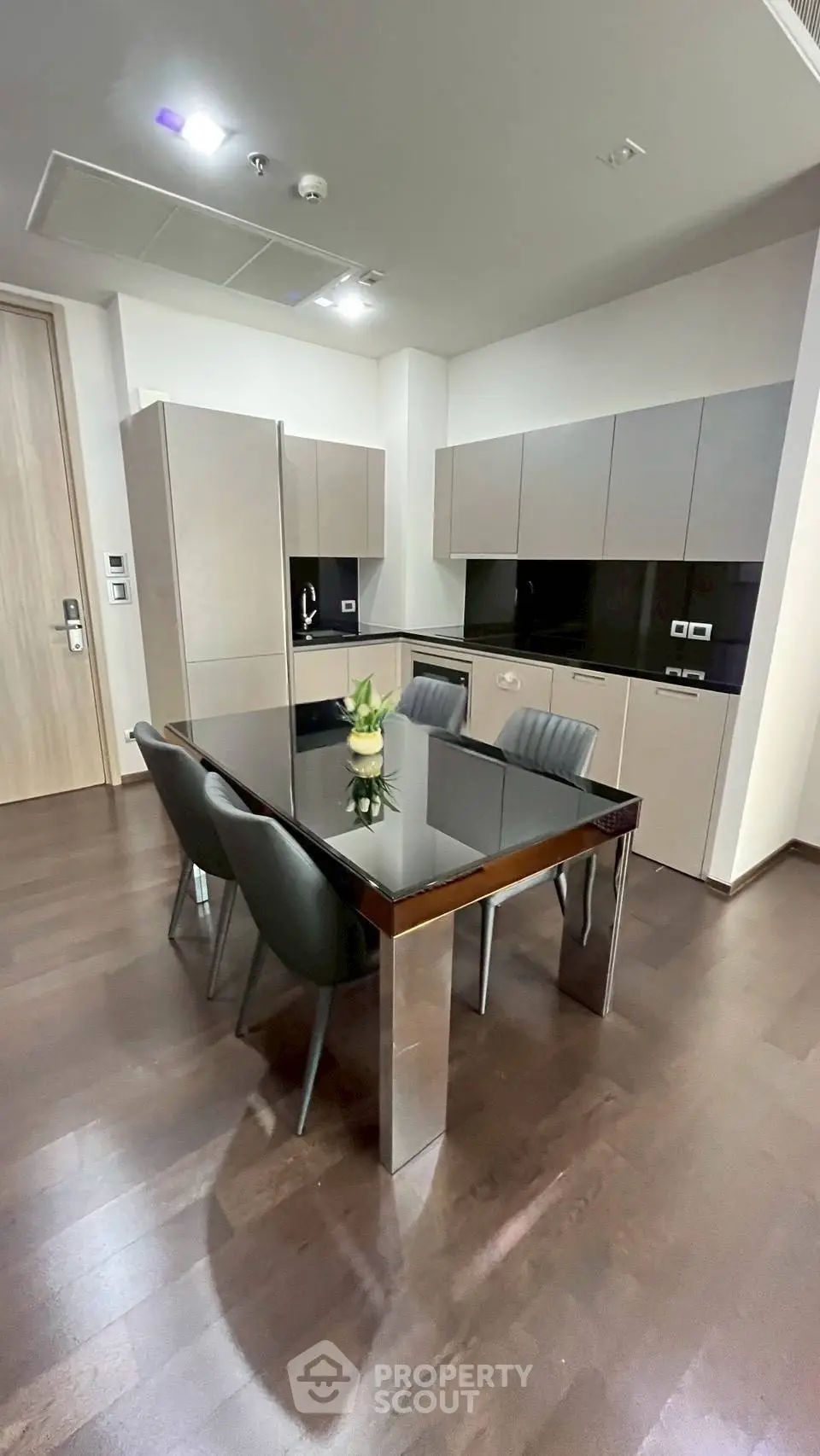 Modern kitchen with sleek cabinets and dining table in contemporary apartment