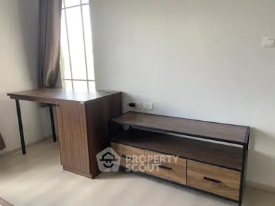 Modern study room with sleek wooden desk and storage unit, ideal for productivity.