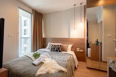 Cozy modern bedroom with stylish decor and ample natural light