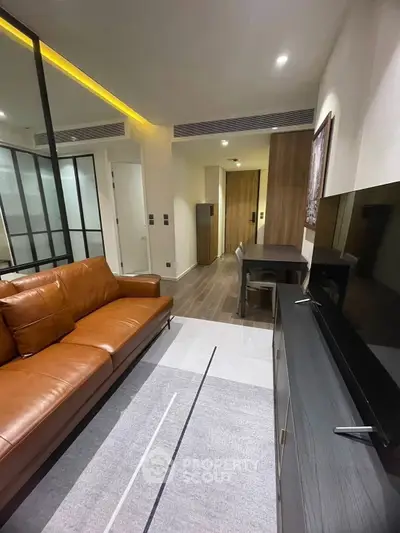 Modern living room with leather sofa and sleek TV unit in stylish apartment