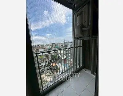 High-rise balcony with cityscape view and safety netting