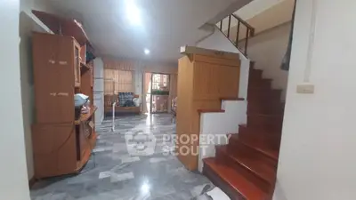 Spacious living area with wooden staircase and modern flooring
