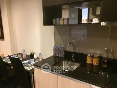 Modern kitchen with sleek cabinetry and dining area, perfect for urban living.