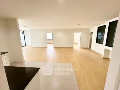 Spacious open-plan living area with modern flooring and ample natural light.