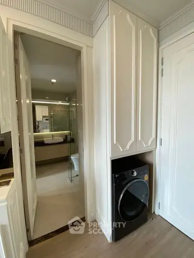 Modern bathroom with sleek washing machine and elegant cabinetry