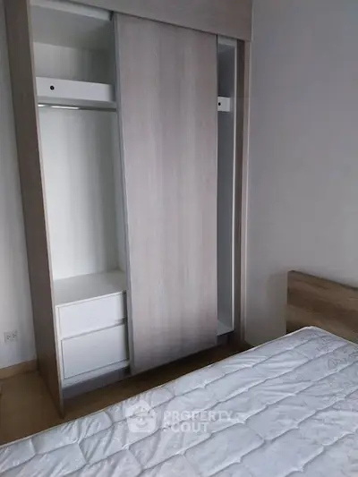 Modern bedroom with sleek wardrobe and comfortable bed