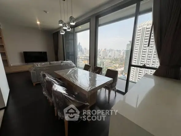 Modern living room with dining area and stunning city view from large windows.