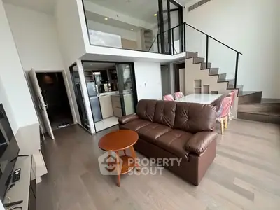 Modern duplex living room with open kitchen and stylish staircase
