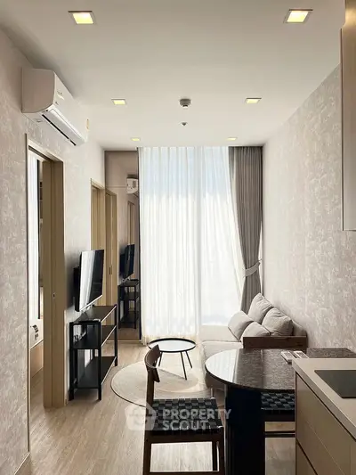 Modern living room with natural light, stylish furniture, and elegant decor in a contemporary apartment.