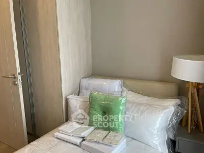 Cozy bedroom with modern decor and neatly arranged bedding, perfect for relaxation.