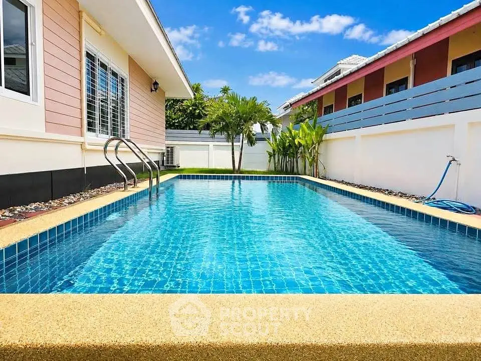 Stunning private pool with clear blue water and lush surroundings in a modern residential property.