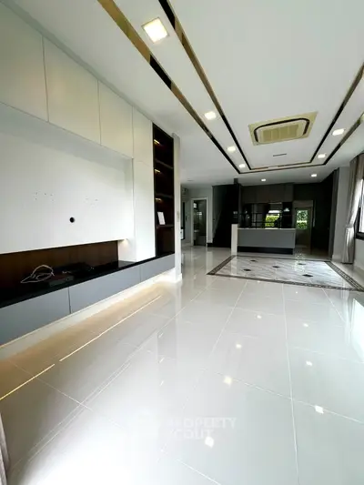 Spacious modern living room with sleek design and open kitchen layout, perfect for contemporary living.