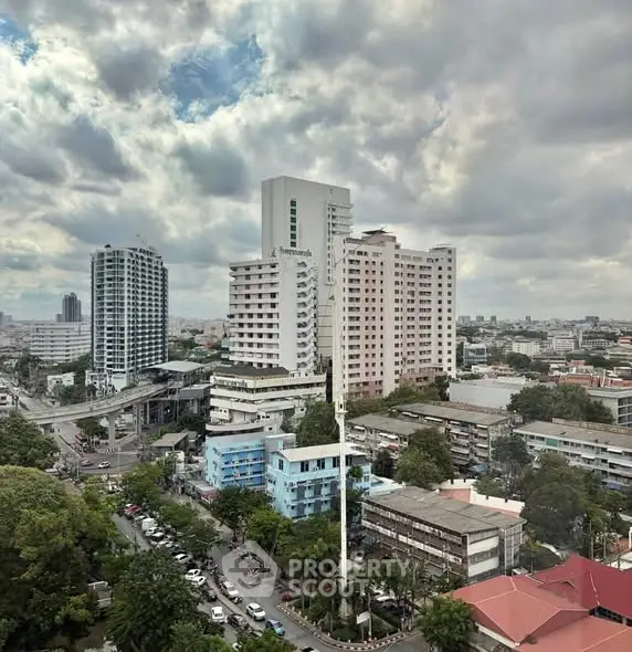 Stunning cityscape view showcasing modern high-rise buildings under a dramatic cloudy sky.