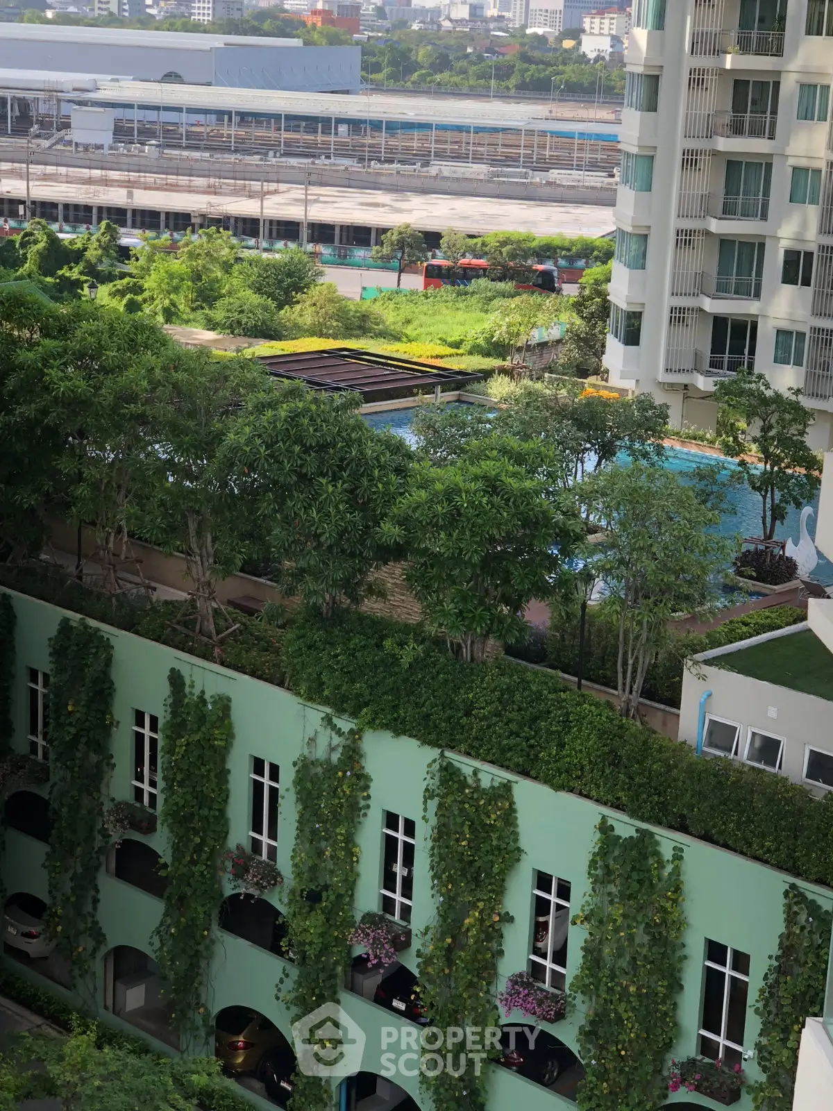Luxurious condo with lush greenery and pool view, perfect for urban living near transport links.