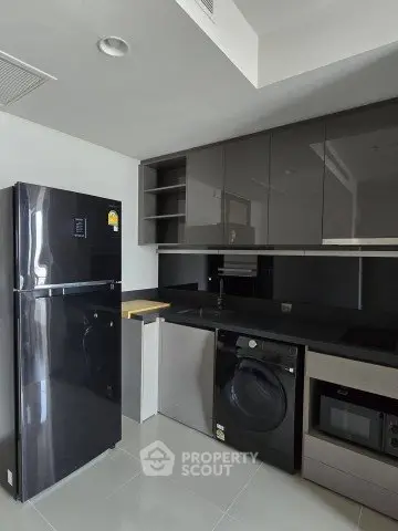 Modern kitchen with sleek black appliances and glossy cabinets