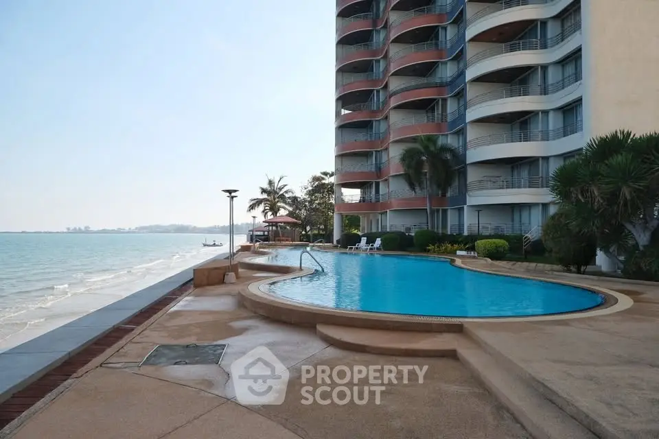 Stunning beachfront condominium with pool and ocean view, perfect for luxury living.