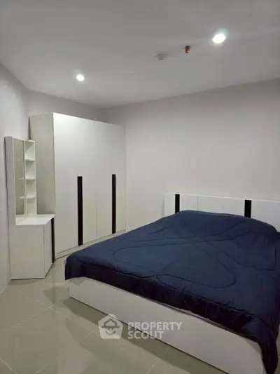Modern bedroom with sleek furniture and cozy ambiance, perfect for relaxation and comfort.