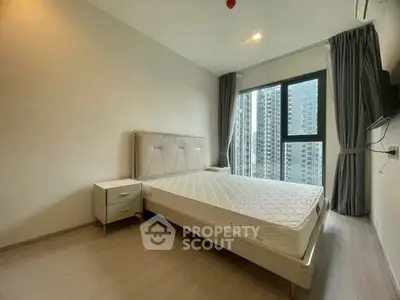 Modern bedroom with large window and city view in high-rise apartment