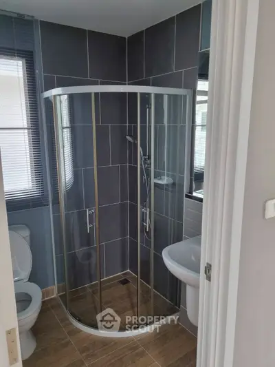 Modern bathroom with glass shower and sleek tile design