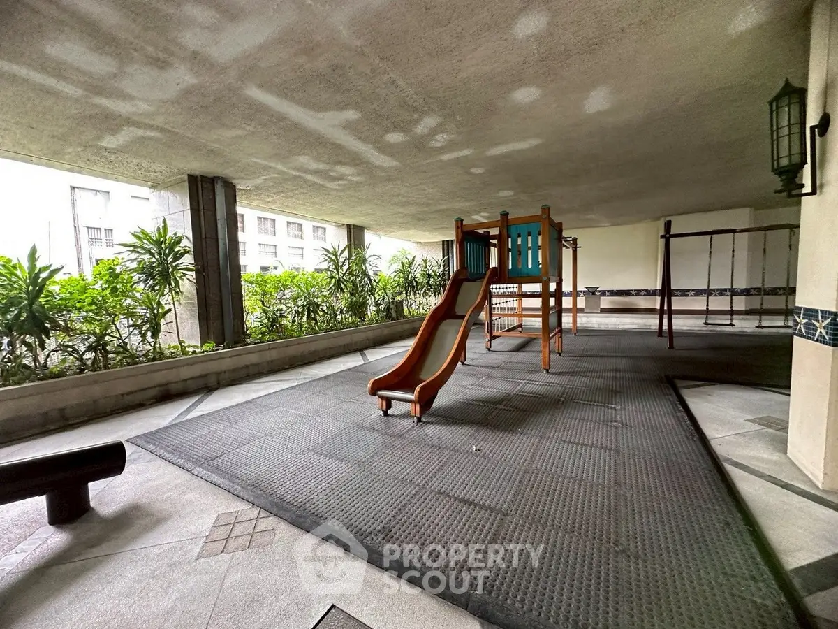 Spacious covered playground area in modern residential complex