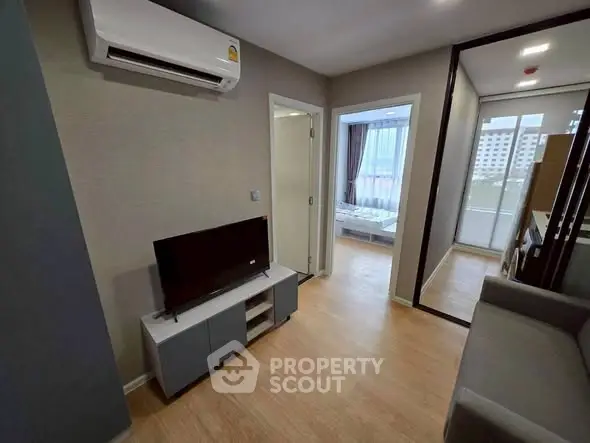 Modern apartment interior with air conditioning and TV, featuring a cozy bedroom view.