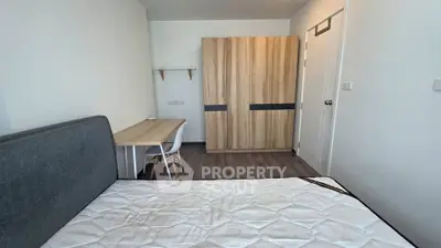 Modern bedroom with stylish wardrobe and study desk, perfect for comfortable living.