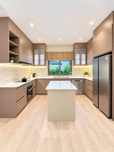 Modern kitchen with sleek cabinetry and central island in a spacious layout.