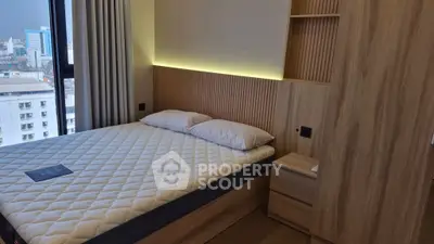 Modern bedroom with city view, featuring a stylish wooden headboard and cozy lighting.