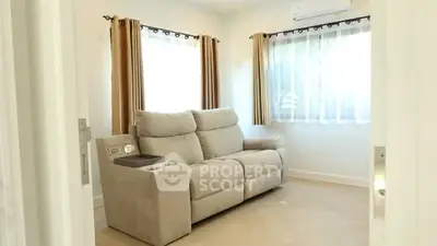 Cozy living room with plush beige sofa and natural light