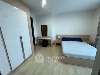 Spacious modern bedroom with minimalist design and ample natural light.
