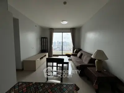 Spacious living room with city view, modern furniture, and large window in high-rise apartment.