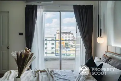 Cozy bedroom with balcony view and modern decor