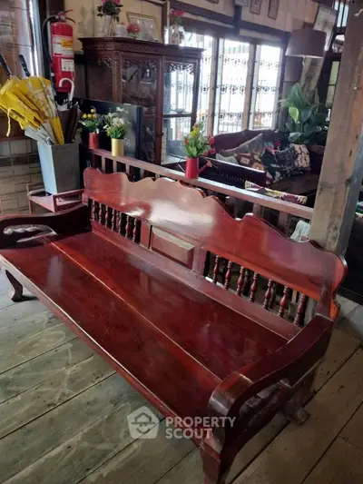 Charming rustic living room with vintage wooden bench and cozy decor.