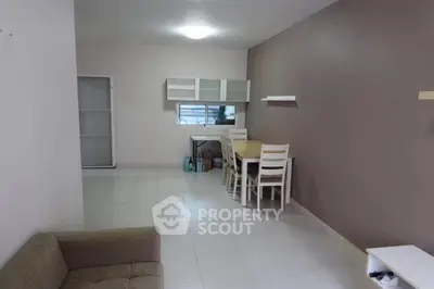 Spacious living room with dining area and modern furniture in a cozy apartment.